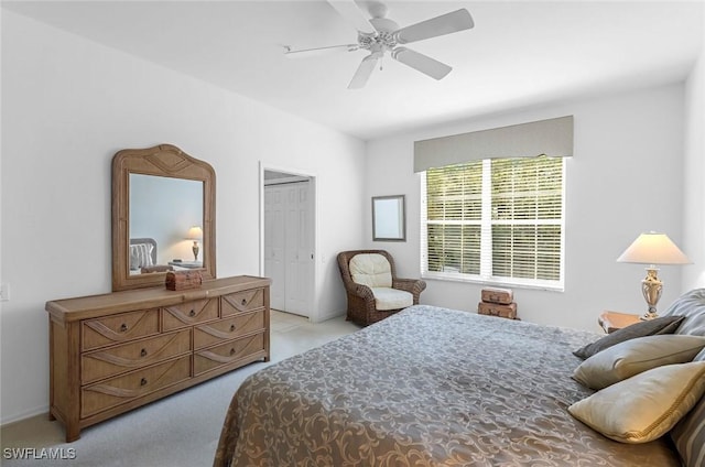 bedroom with light colored carpet and a ceiling fan