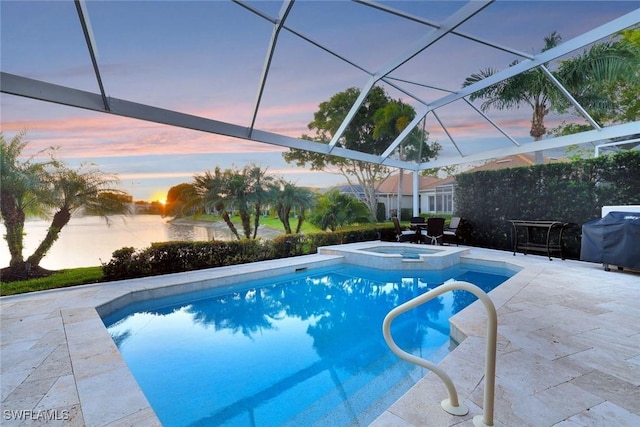 pool at dusk with a patio, area for grilling, and a lanai