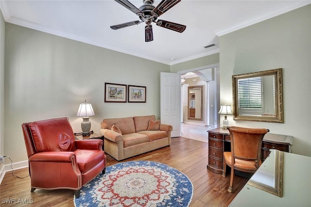 living room with visible vents, arched walkways, hardwood / wood-style floors, and a ceiling fan