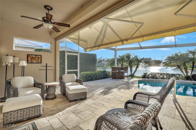 view of patio / terrace featuring an outdoor pool, glass enclosure, and ceiling fan