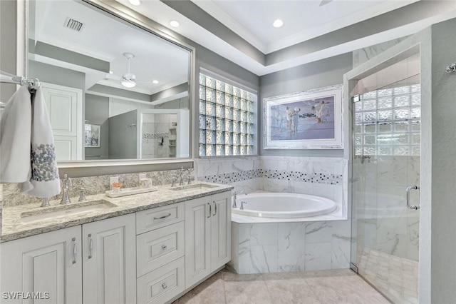 bathroom with a sink, a marble finish shower, and crown molding