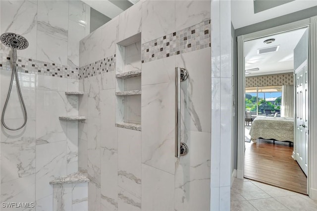 bathroom featuring a marble finish shower and ensuite bathroom