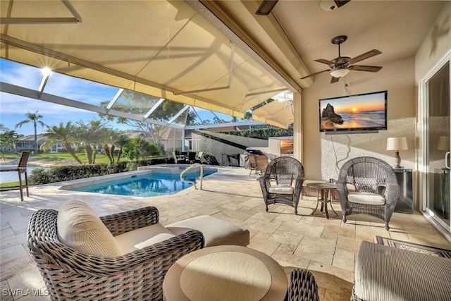 pool with a patio area, a lanai, and ceiling fan