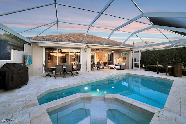 view of pool with outdoor dining space, a patio, area for grilling, a pool with connected hot tub, and outdoor lounge area