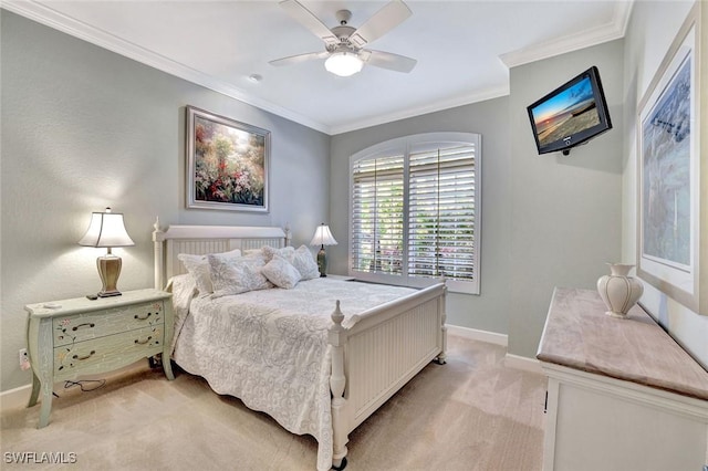 bedroom featuring baseboards, light colored carpet, ceiling fan, and crown molding