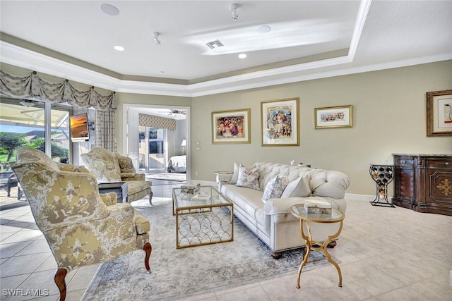 living room with visible vents, a tray ceiling, crown molding, tile patterned flooring, and baseboards