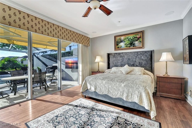 bedroom with wood-type flooring, a sunroom, ornamental molding, and access to exterior