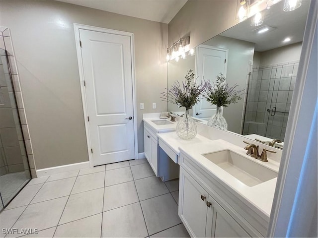 full bath featuring baseboards, double vanity, a stall shower, tile patterned floors, and a sink