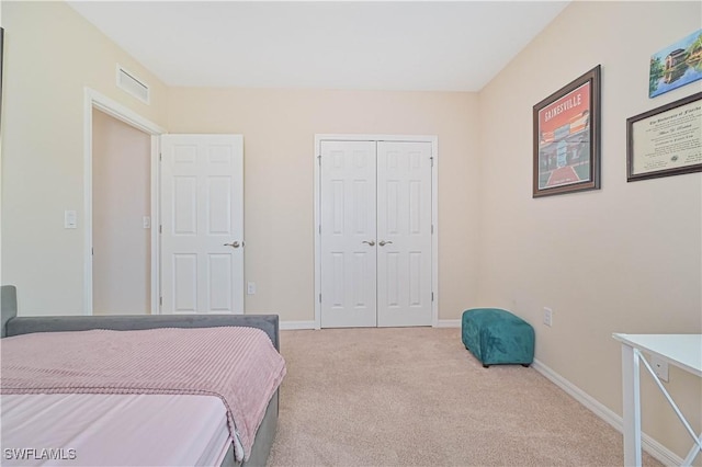 bedroom with a closet, baseboards, visible vents, and carpet flooring