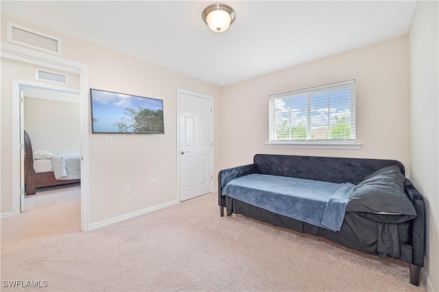 bedroom featuring light carpet, visible vents, and baseboards