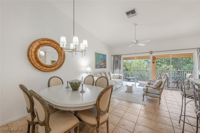 dining area featuring light tile patterned floors, ceiling fan with notable chandelier, visible vents, and high vaulted ceiling