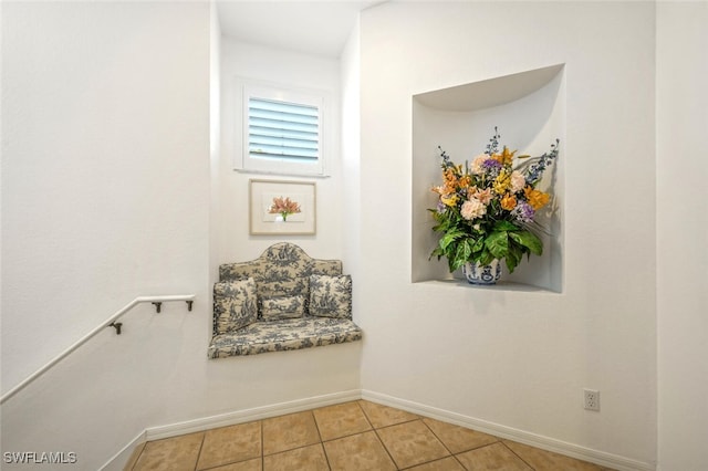 interior space featuring light tile patterned floors and baseboards