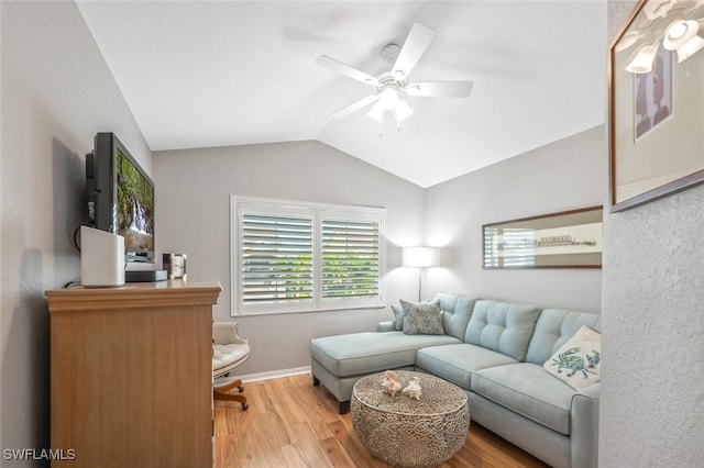 living area with ceiling fan, baseboards, lofted ceiling, and wood finished floors