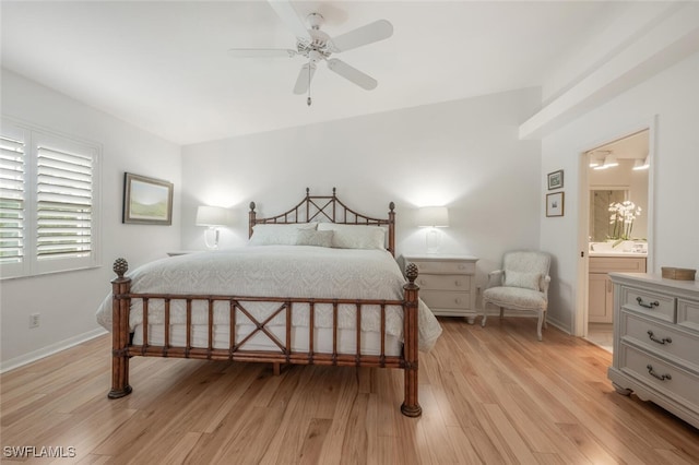 bedroom with ensuite bath, baseboards, and light wood-style floors