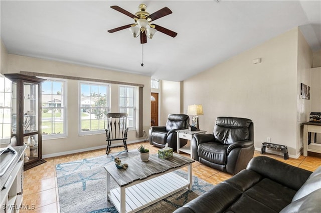 living room with light tile patterned floors, baseboards, and a ceiling fan