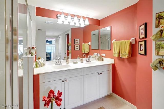 ensuite bathroom with double vanity, visible vents, ensuite bathroom, a sink, and tile patterned flooring