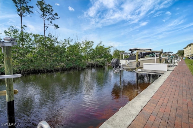 dock area with a water view and boat lift