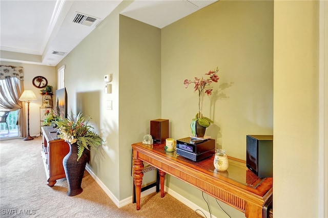 hallway featuring carpet floors, baseboards, and visible vents