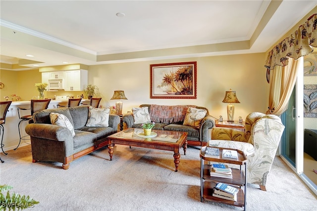 living area with a tray ceiling and light colored carpet