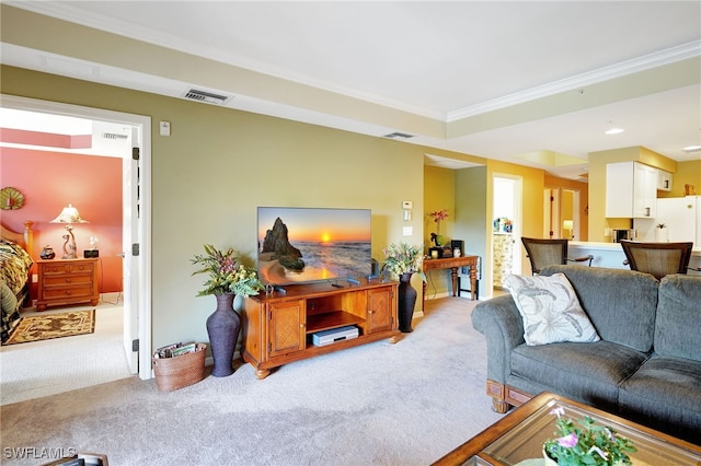 carpeted living room featuring visible vents and crown molding