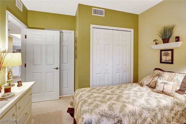 bedroom with light carpet, a closet, and visible vents