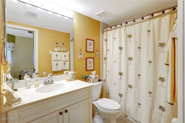 bathroom with toilet, visible vents, a shower with shower curtain, and vanity