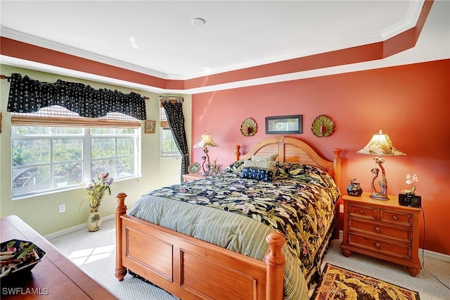 bedroom featuring baseboards, crown molding, and light colored carpet