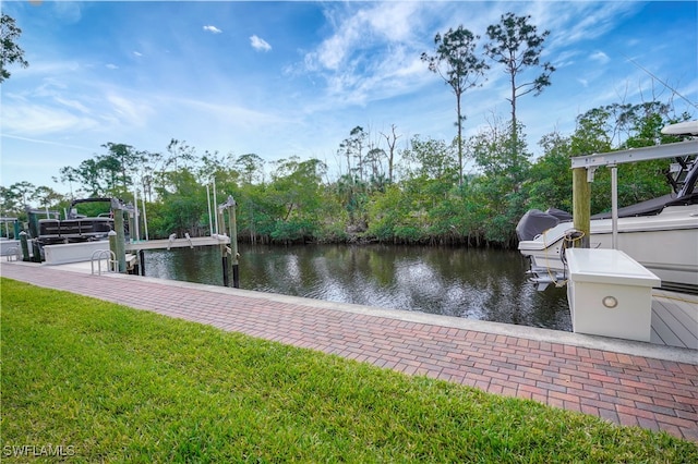 dock area featuring a lawn, a water view, and boat lift