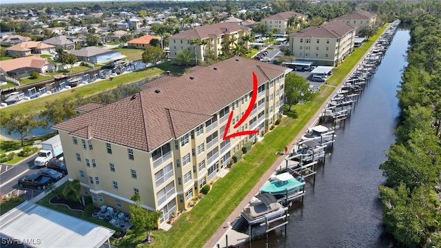 bird's eye view featuring a water view and a residential view