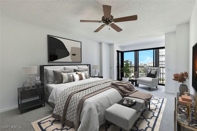 carpeted bedroom featuring access to exterior, a textured ceiling, baseboards, and ceiling fan