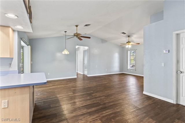 unfurnished living room featuring lofted ceiling, ceiling fan, visible vents, baseboards, and dark wood finished floors