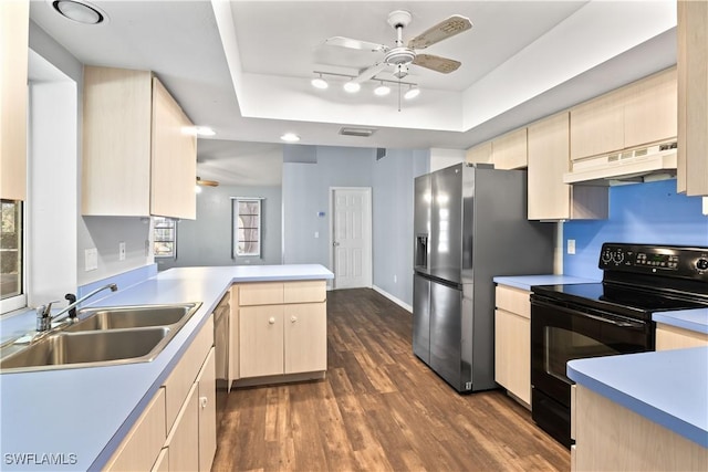 kitchen with under cabinet range hood, a sink, black electric range, a tray ceiling, and stainless steel fridge