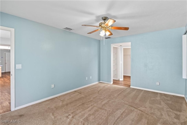 unfurnished bedroom featuring carpet, visible vents, and baseboards