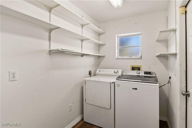 washroom with laundry area, baseboards, and washer and clothes dryer