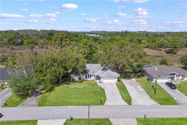 birds eye view of property featuring a view of trees