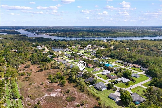 bird's eye view featuring a residential view, a water view, and a view of trees