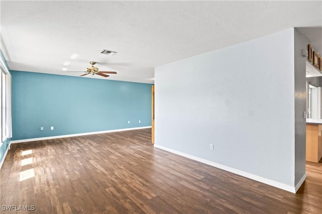 unfurnished room featuring visible vents, baseboards, and wood finished floors