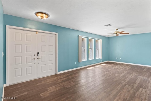 foyer entrance featuring baseboards, visible vents, ceiling fan, and wood finished floors