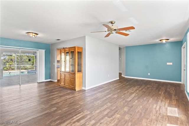 unfurnished living room with visible vents, ceiling fan, baseboards, and wood finished floors