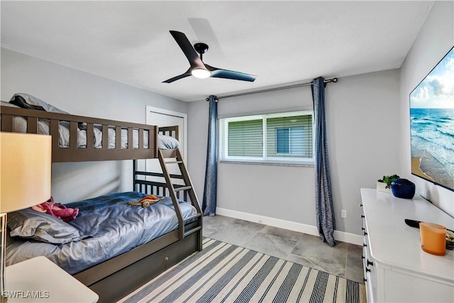 bedroom with ceiling fan and baseboards