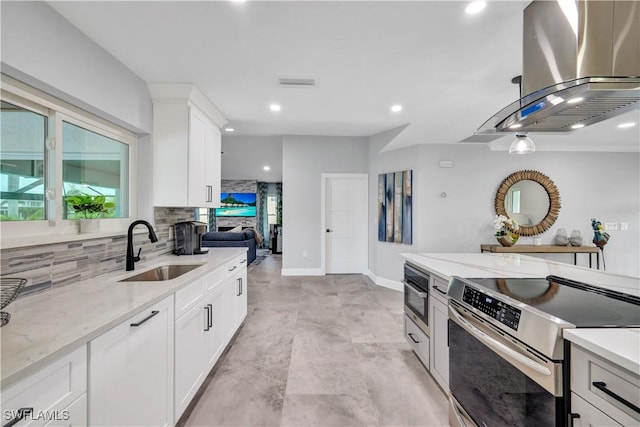 kitchen featuring island range hood, a sink, visible vents, stainless steel electric range, and decorative backsplash