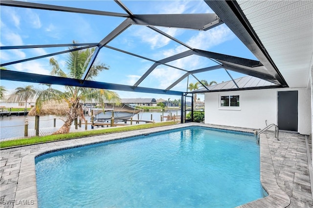 pool with a dock, glass enclosure, and a water view