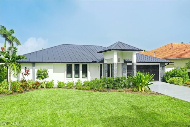 view of front of property with stucco siding, a front yard, a standing seam roof, metal roof, and a garage