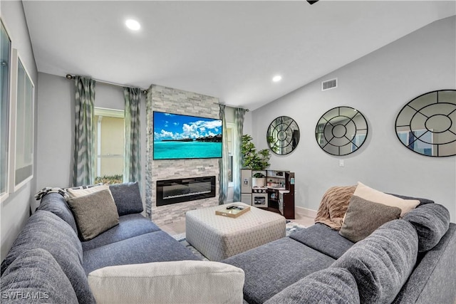 living area with a large fireplace, baseboards, visible vents, vaulted ceiling, and recessed lighting