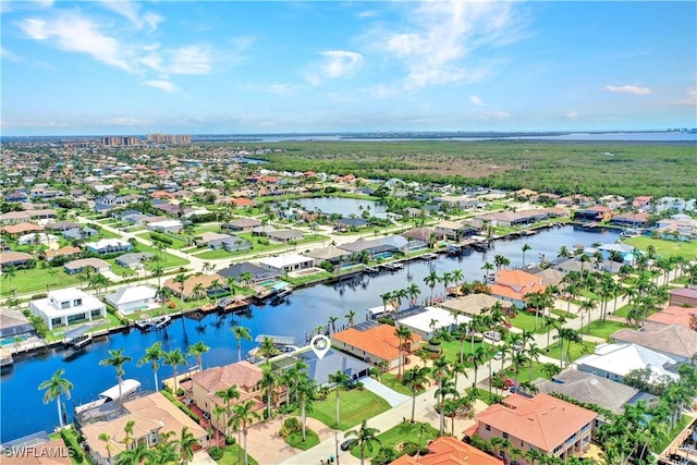 drone / aerial view featuring a residential view and a water view