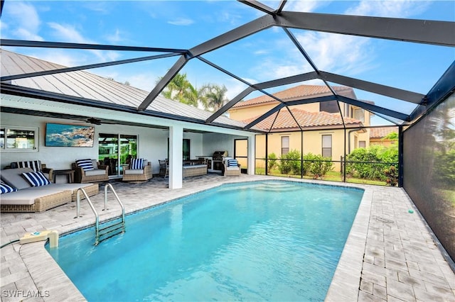 outdoor pool featuring a patio area, glass enclosure, outdoor lounge area, and a ceiling fan