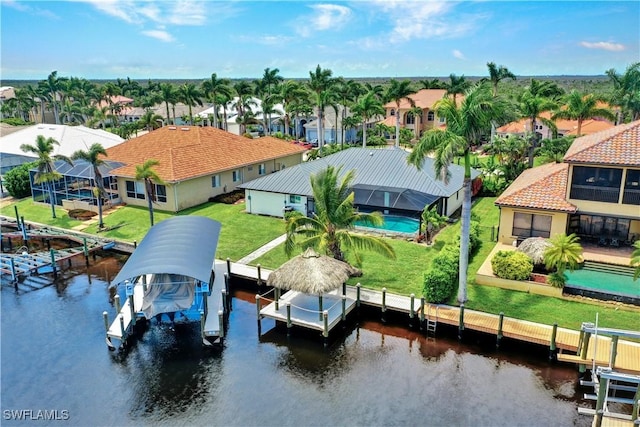 drone / aerial view featuring a water view and a residential view