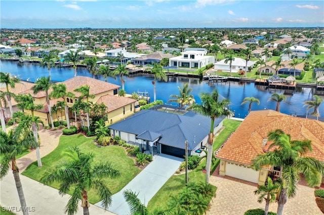 drone / aerial view with a water view and a residential view