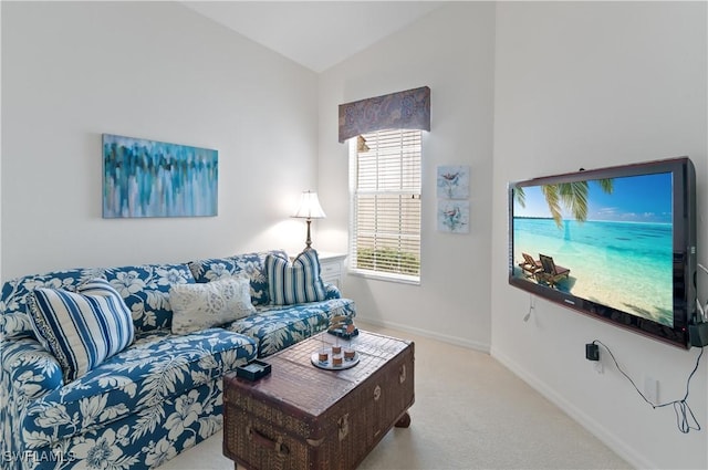 living area with baseboards, carpet floors, and vaulted ceiling