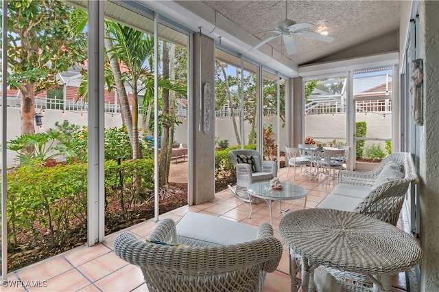 sunroom / solarium with plenty of natural light, a ceiling fan, and vaulted ceiling